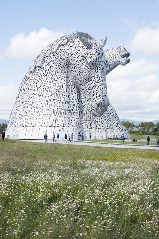 Kelpies horse monuments in grassy field Kelpies horse monuments surrounded by scattered clouds in grassy field at Falkirk, Scotland