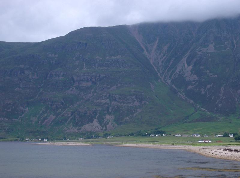 Beach and small settlement on the shores of a loch Beach and small settlement on the shores of a loch in the Scottish highlands pictured on a cold misty day