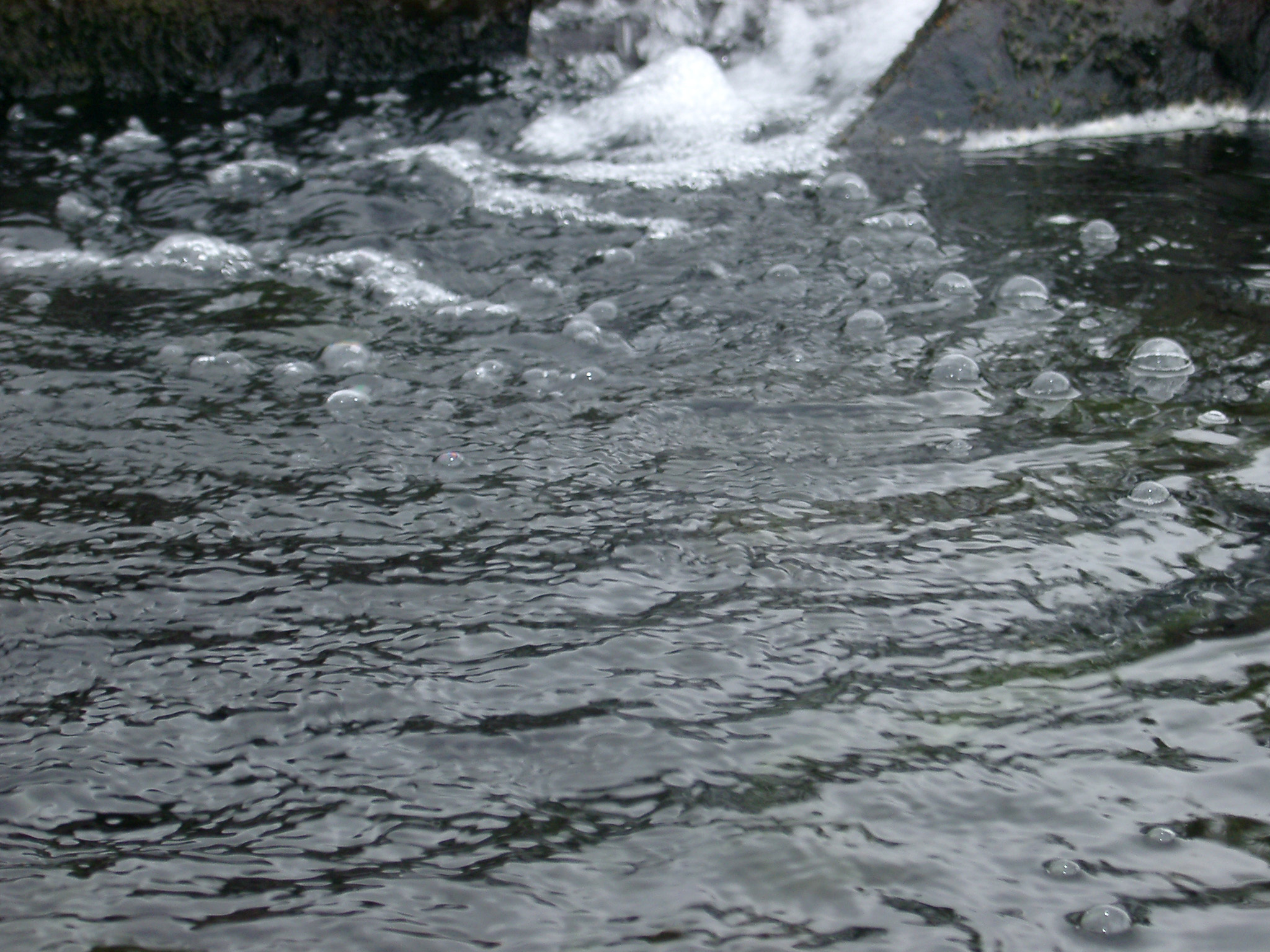an image of Bubbling water in a fast flowing stream in a full frame background texture