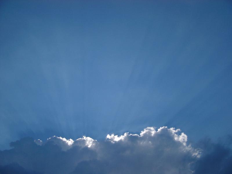clouds on a blue sky Bank of white clouds catching the rays of sunshine in a blue sky with copyspace for your text