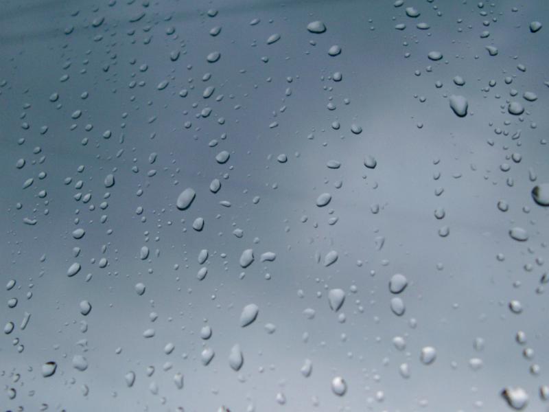 Close up Shot of Conceptual Rain Drops on Glass Window. Can be Used for Wallpaper Backgrounds.