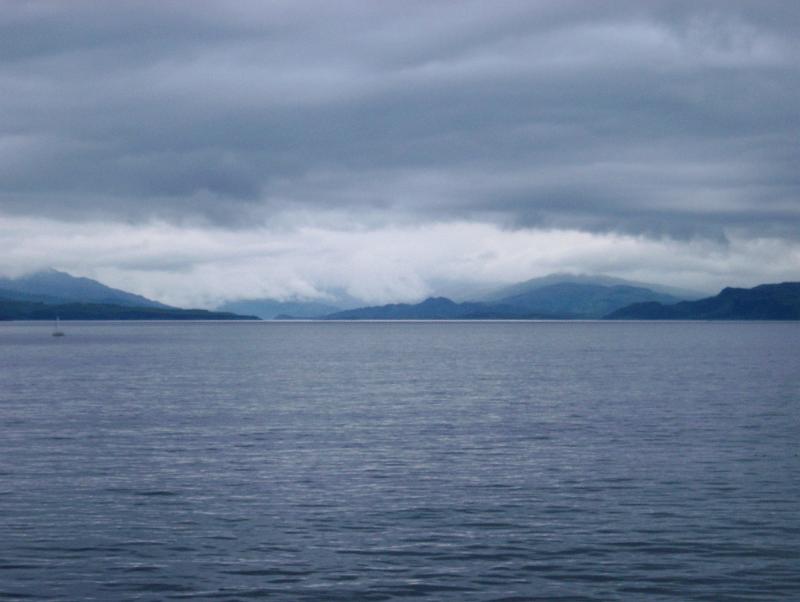 Scottish lochs View over a calm ocean on a stormy overcast day of Scottish lochs and distant mountains