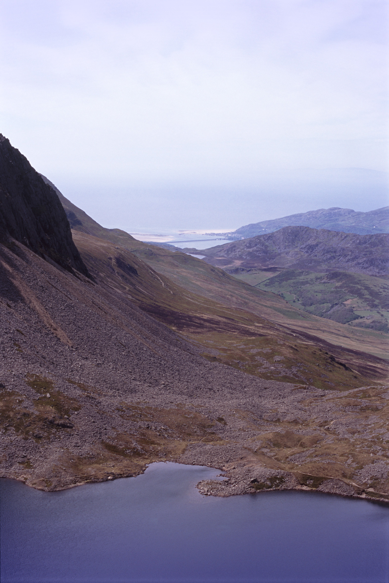 an image of View from Cadair Idris, a popular mountain in Gwynedd, Wales for hikers, towards Barmouth and the coast
