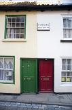 red and green entrance front doors of caedmon cottages whitby