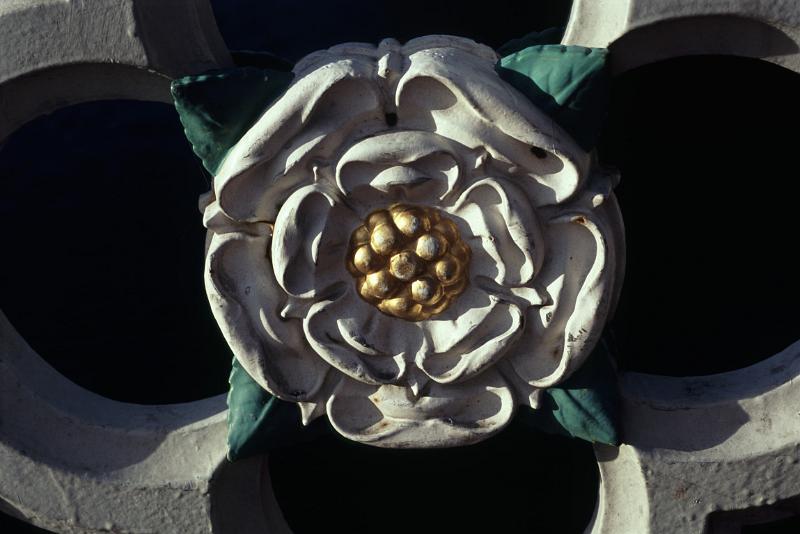 Close up Simple Vintage White Rose Sculpture at Minister Rose Window with Black Background.