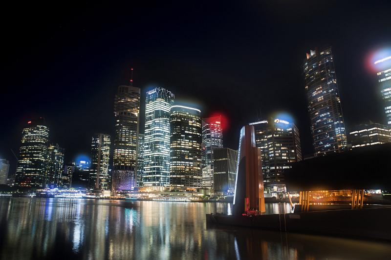 Night cityscape with illuminated skyscrapers reflecting in water, Brisbane, Australia
