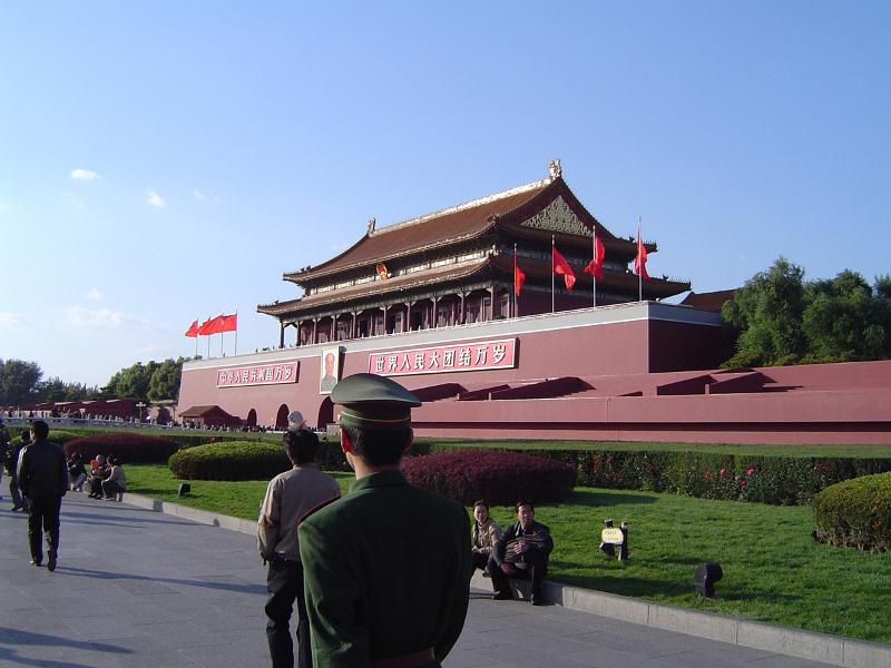 Famous Historic Temple at Forbidden City in Beijing China with Random Tourists on Light Blue Sky Background.
