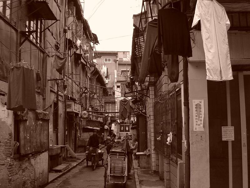 Vintage Ordinary Busy Chinese Street Scene at Poor Area with Big Houses on the Sides.