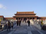 Random Visitors at Famous Chinese Attraction, Forbidden City Temple in Beijing, on Lighter Blue Sky Background.
