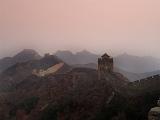 Great Wall of China built to defend the Empire snaking across mountains and valleys on a misty day with smog
