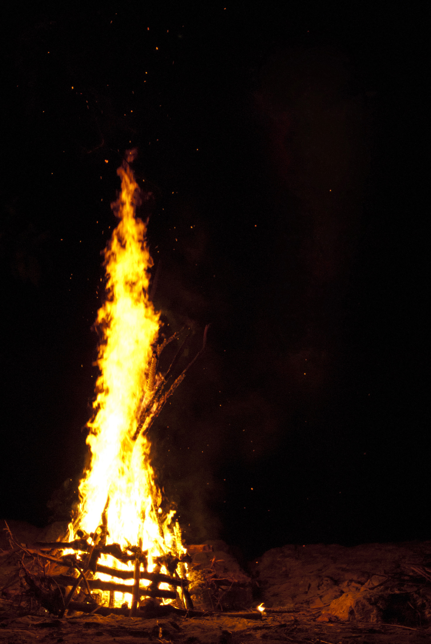 an image of Blazing camp fire with flames leaping into the night sky and copyspace for your text