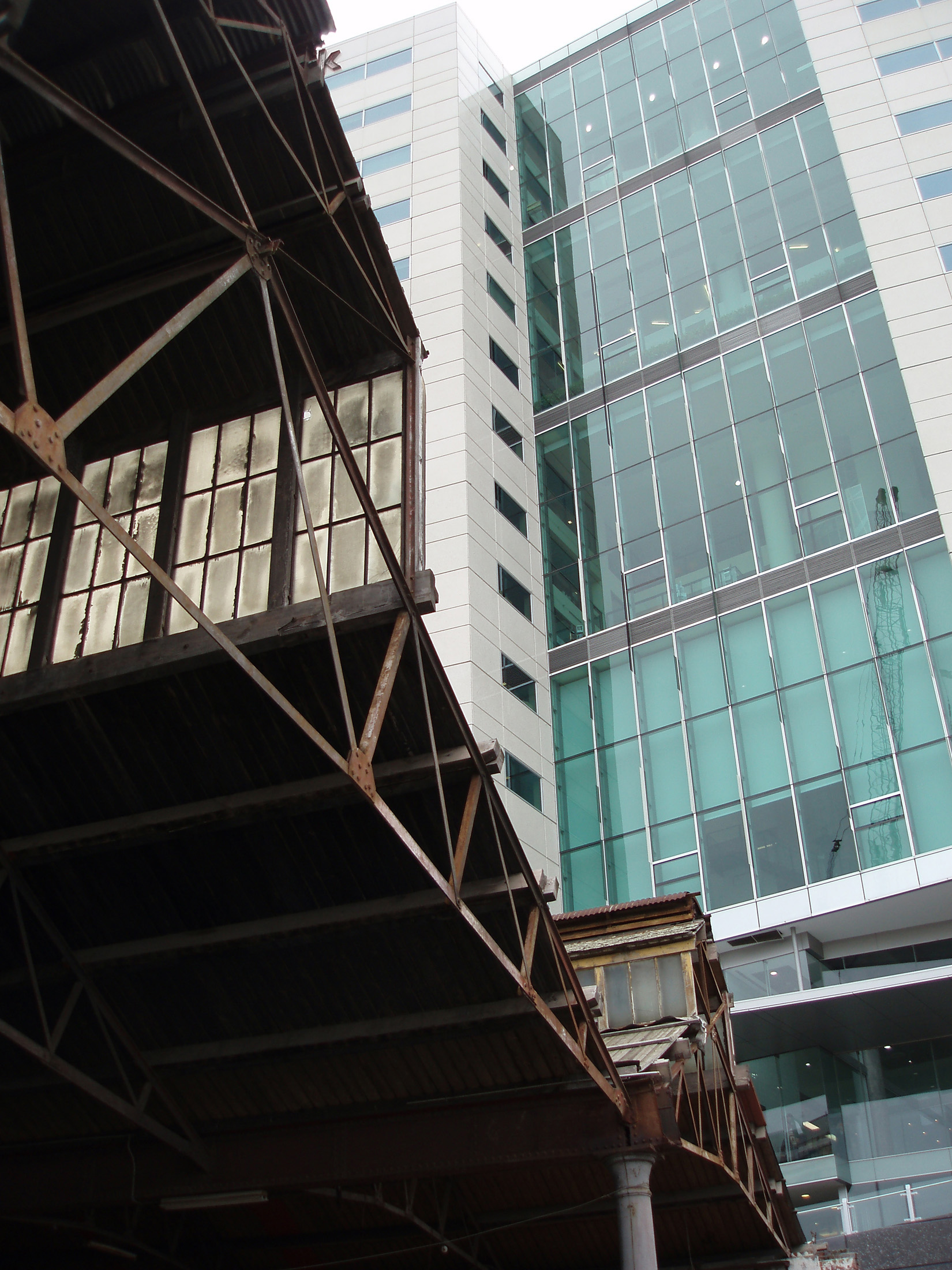 an image of Looking Up at Abandoned Railway Shed and Modern Highrise Building, Melbourne, Australia