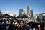 A bustling, busy rooftop bar on a clear, blue day in the centre of Melbourne city, Australia.