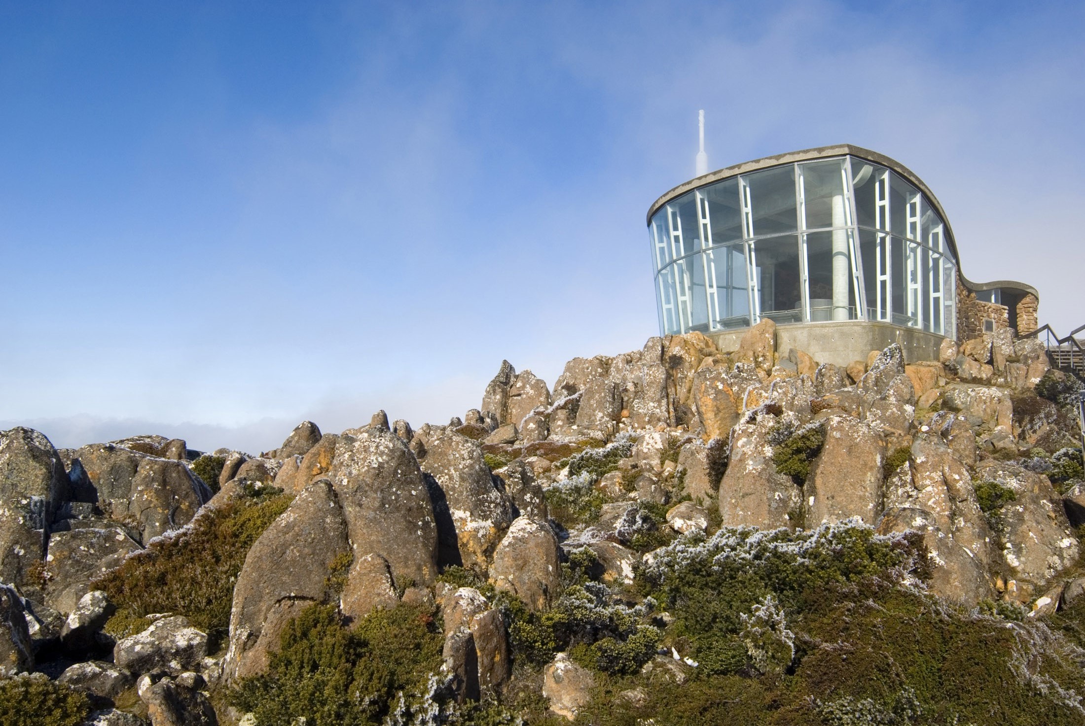 an image of glass viewing shelter on top of mount wellington fends winter winds from visting tourists, hobart, tasmania