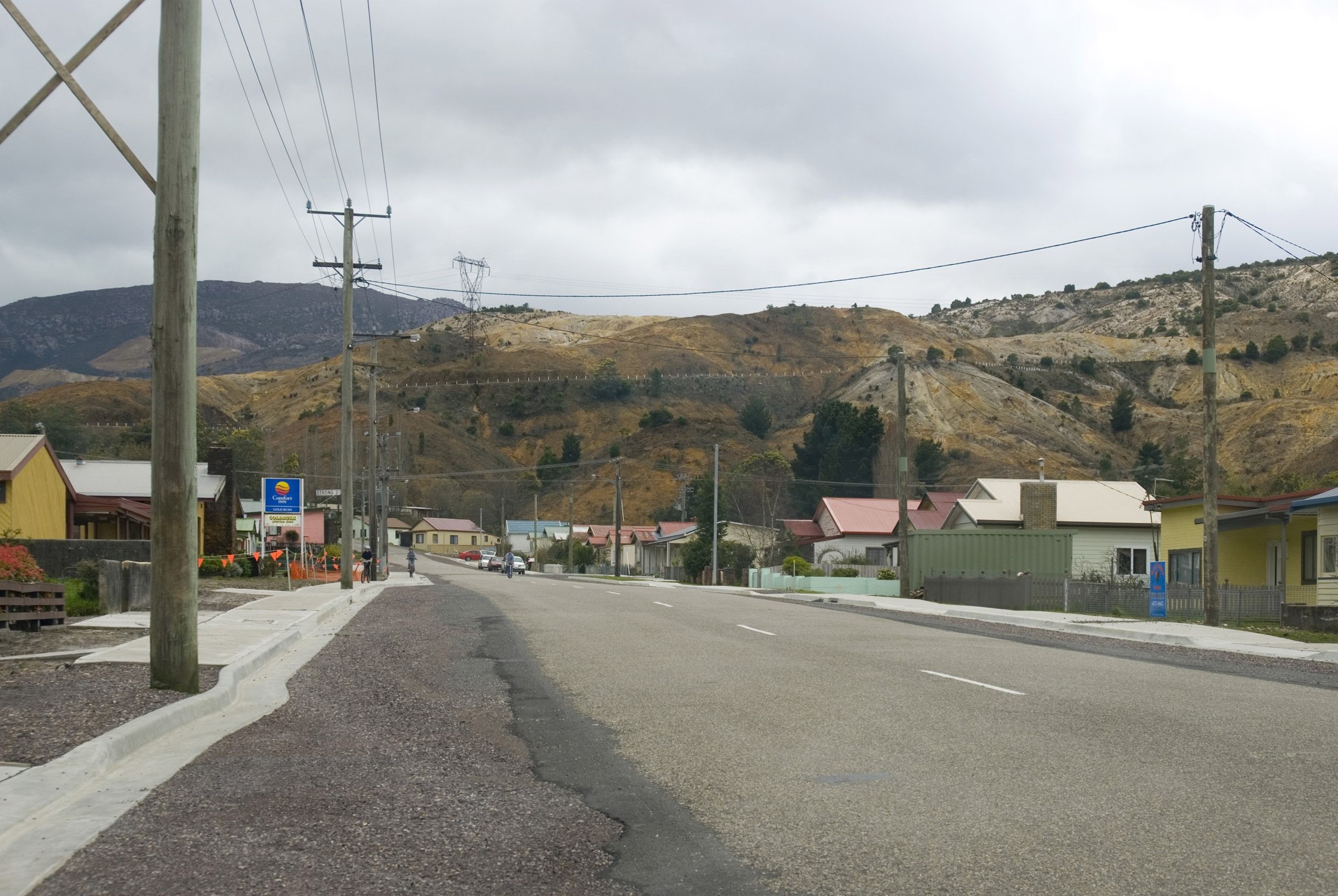 an image of a street in the tasmanian mining town of queenston, surrounded by spoil heaps