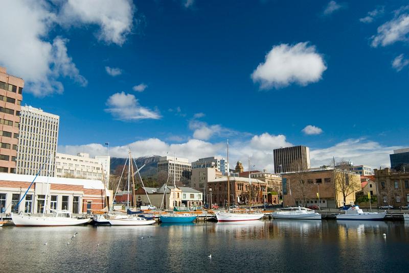 a sunny day at hobart docks, with the CBD and mount wellington in the distance
