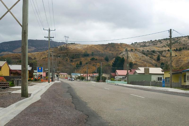 a street in the tasmanian mining town of queenston, surrounded by spoil heaps