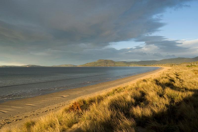 early evening with dark storm clouds over 7 mile beach, hobart, tasmania