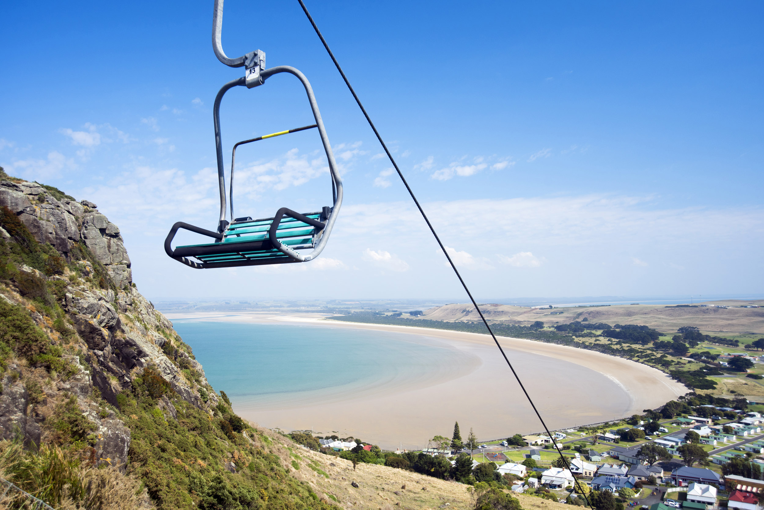 an image of An empty mountain chairlift with a beautiful panoramic view of the coast in Stanley, Tasmania.