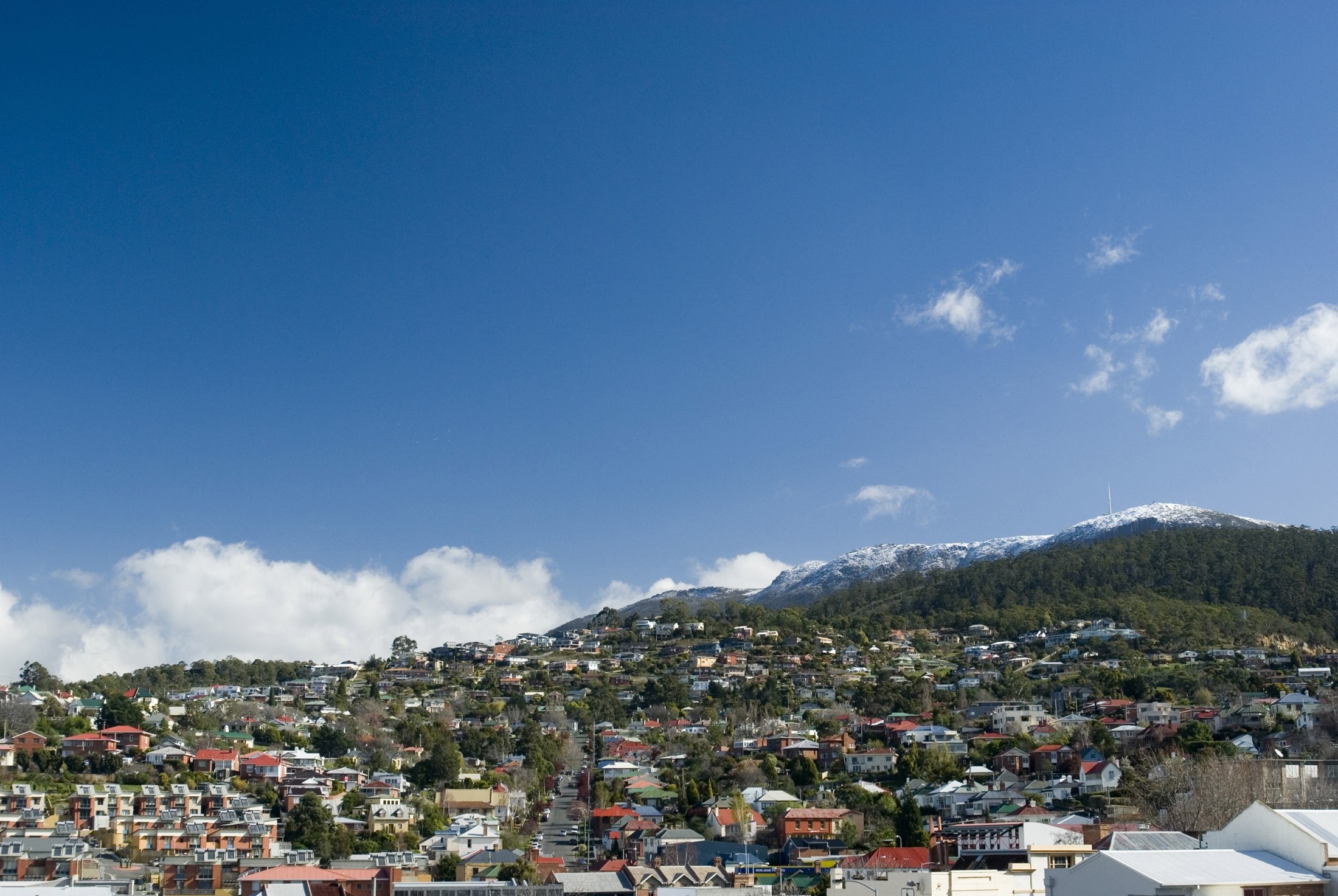an image of a clear winter day with snow on top of mount wellington, hobrart, tasmania