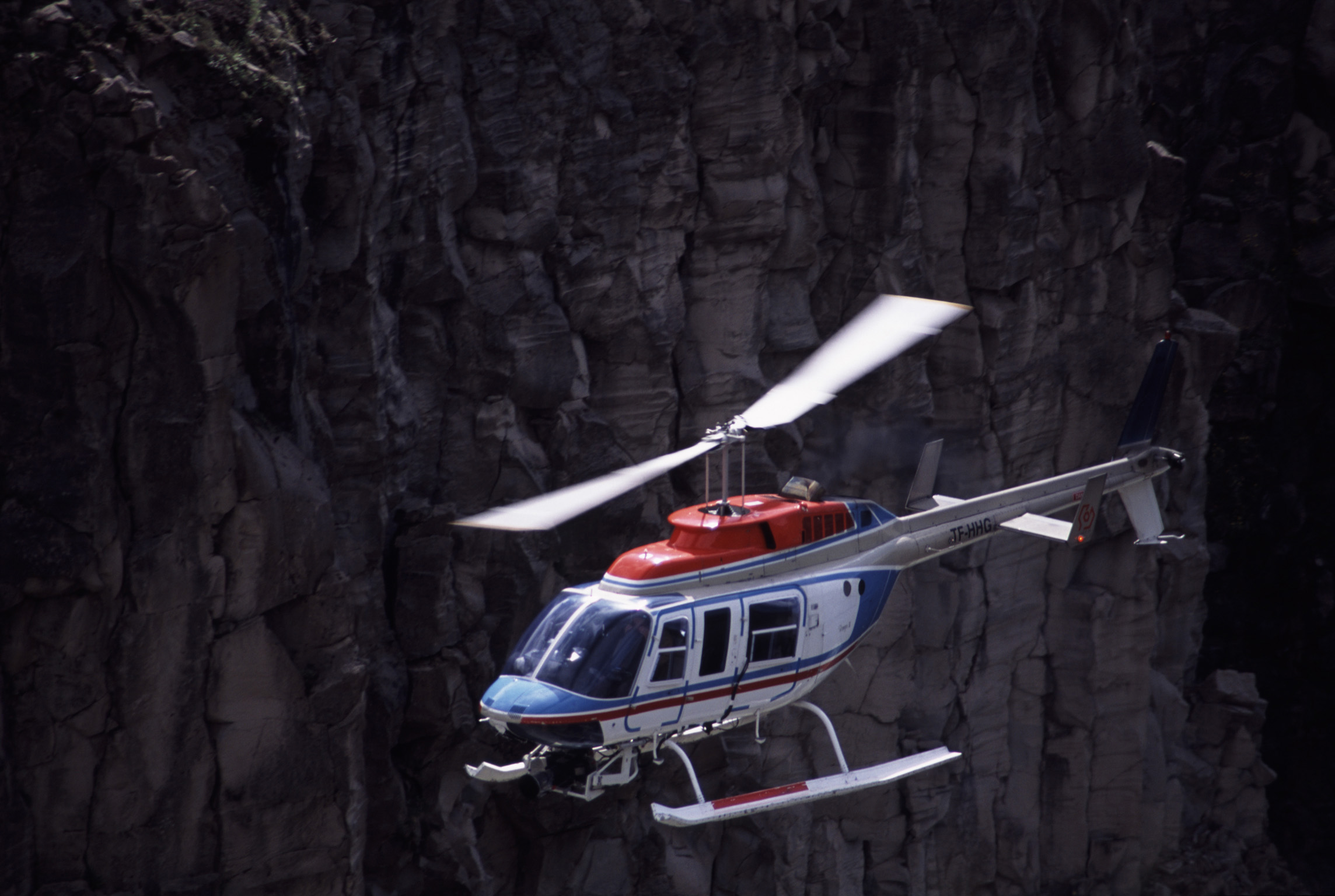an image of Helicopter on a sightseeing flight flying on a dark background with copyspace conceptual of travel and vacations