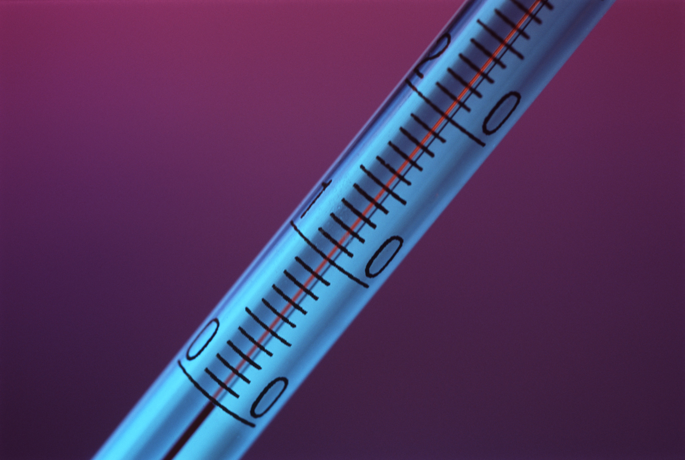 an image of Close up of a thermometer showing the scale on the glass of the tume and the temperature graduations
