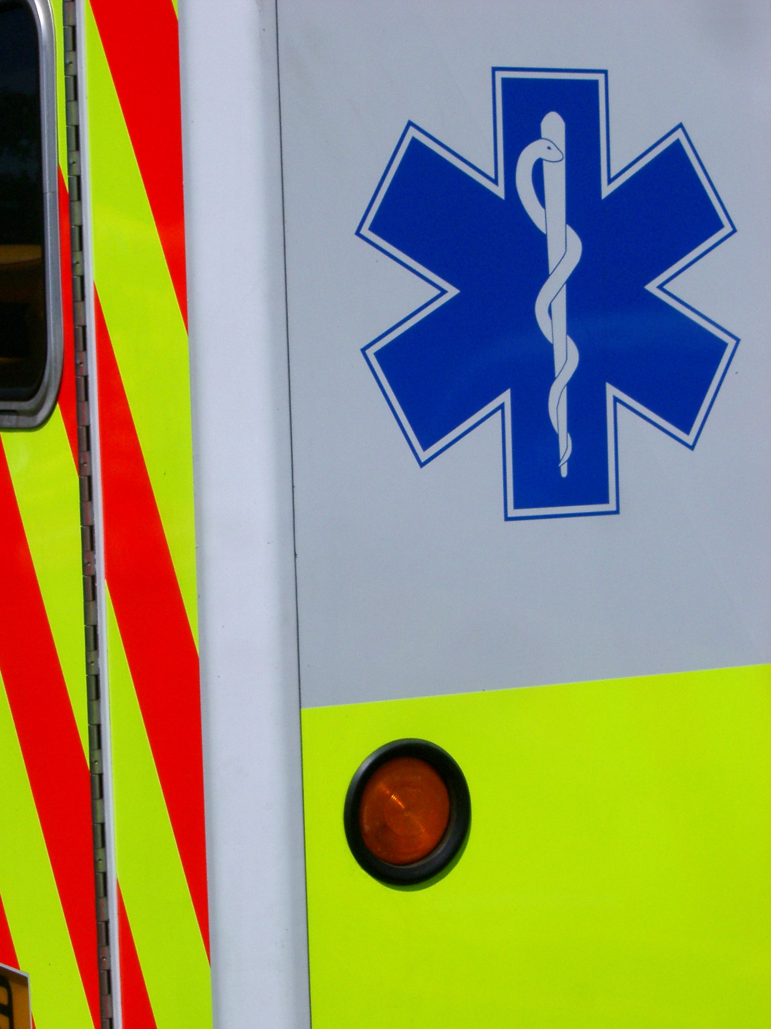 an image of Close Up of Caduceus Medical Symbol on Rear Corner of Ambulance Vehicle