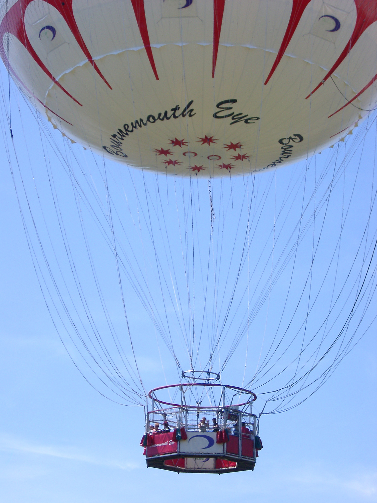 an image of Low Angle View of Hot Air Balloon in Flight in Blue Sky
