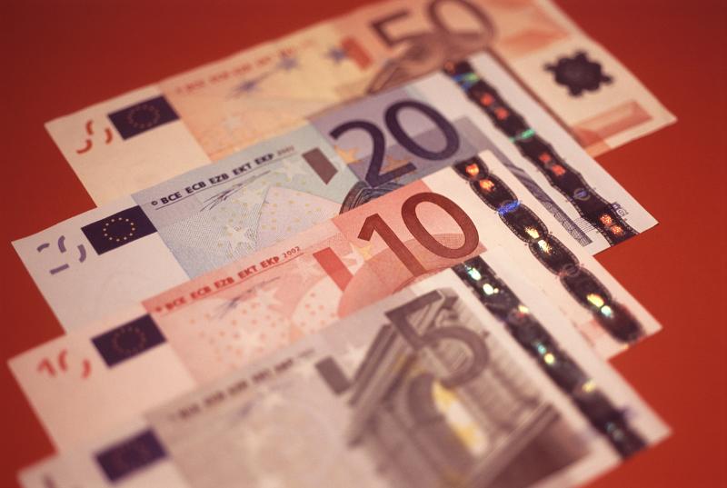Background of euro banknotes Background of euro banknotes arranged in an overlapping receding row with different denominations visible