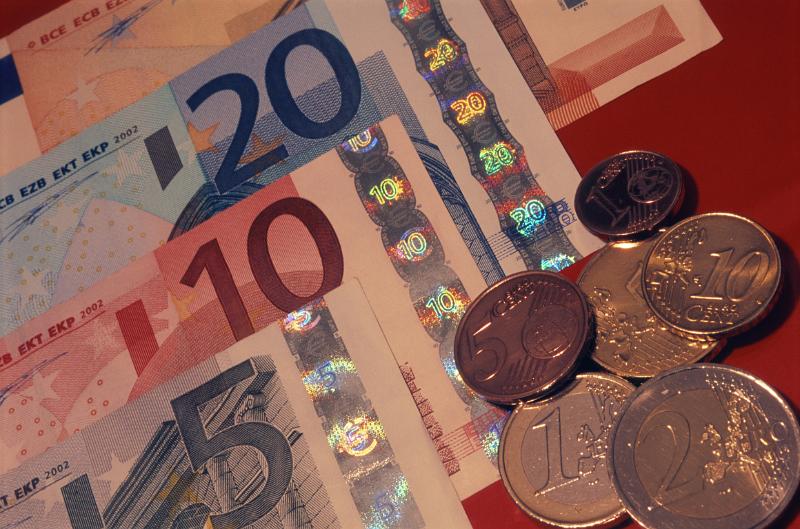 Close Up of Euro Bills and Coin Currency Close Up Still Life of Euro Bills and Coin Currency on Red Background