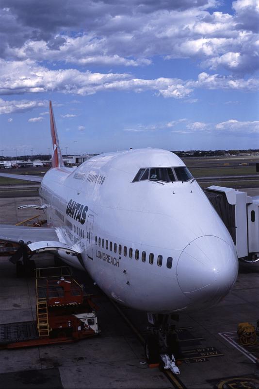 Preparing Airplane for Take Off at Airport Preparing Airplane for Take Off on Tarmac at Airport with Boarding Bridge Attached
