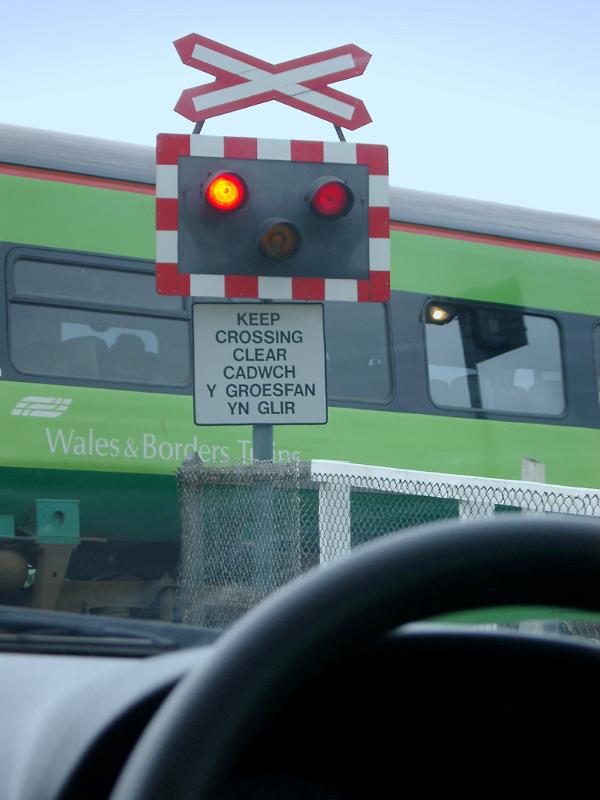 Car Waiting at Railway Crossing for Train to Pass Driver Perspective of Car Waiting at Railway Crossing with Signals Flashing for Train to Pass