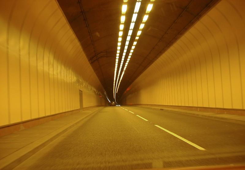 Road Level View of Road Tunnel with Yellow Lighting