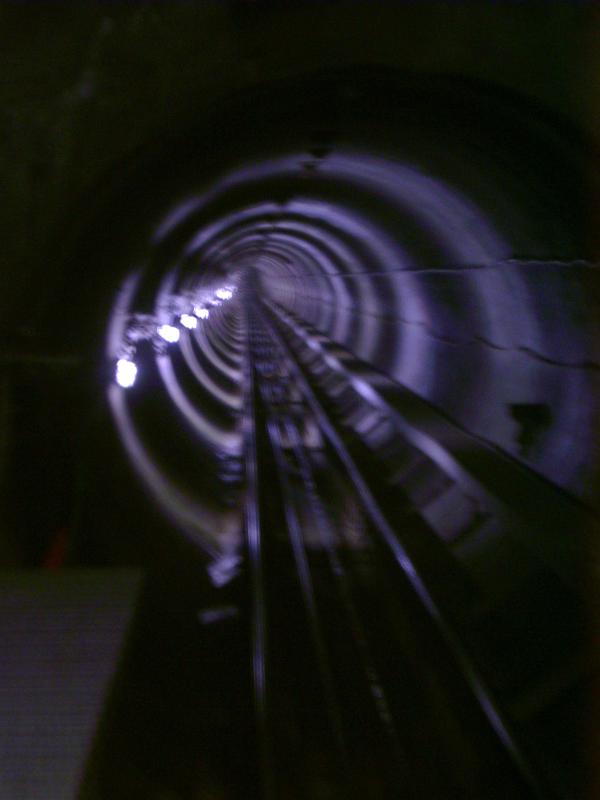 Receding view of a rail tunnel Blurred receding view of a rail tunnel taken from a moving train disappearing in to the darkness in a rail travel, commuting, and vacation concept