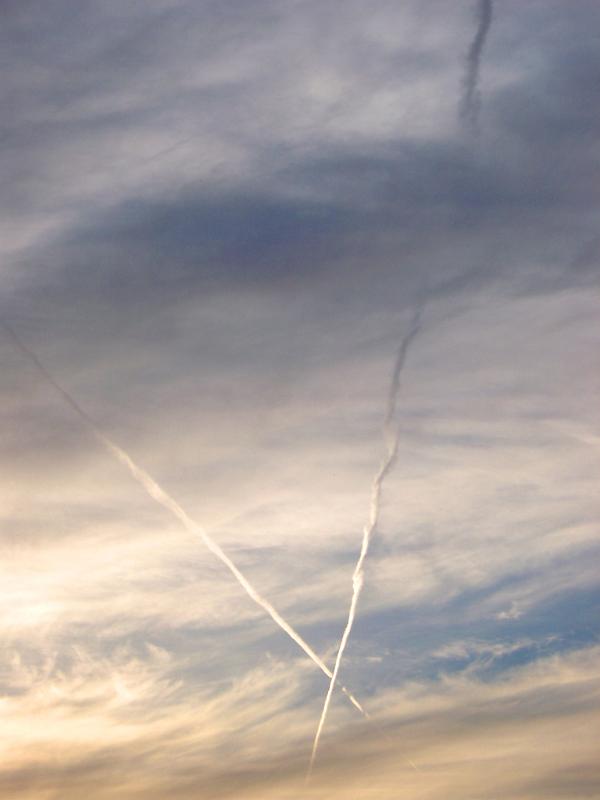 Low Angle View of Airplane Vapor Crossing in Cloudy Sky