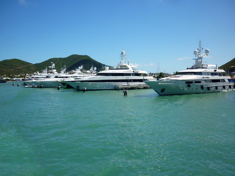 a line of super yachts docked on the caribbean island of st martin