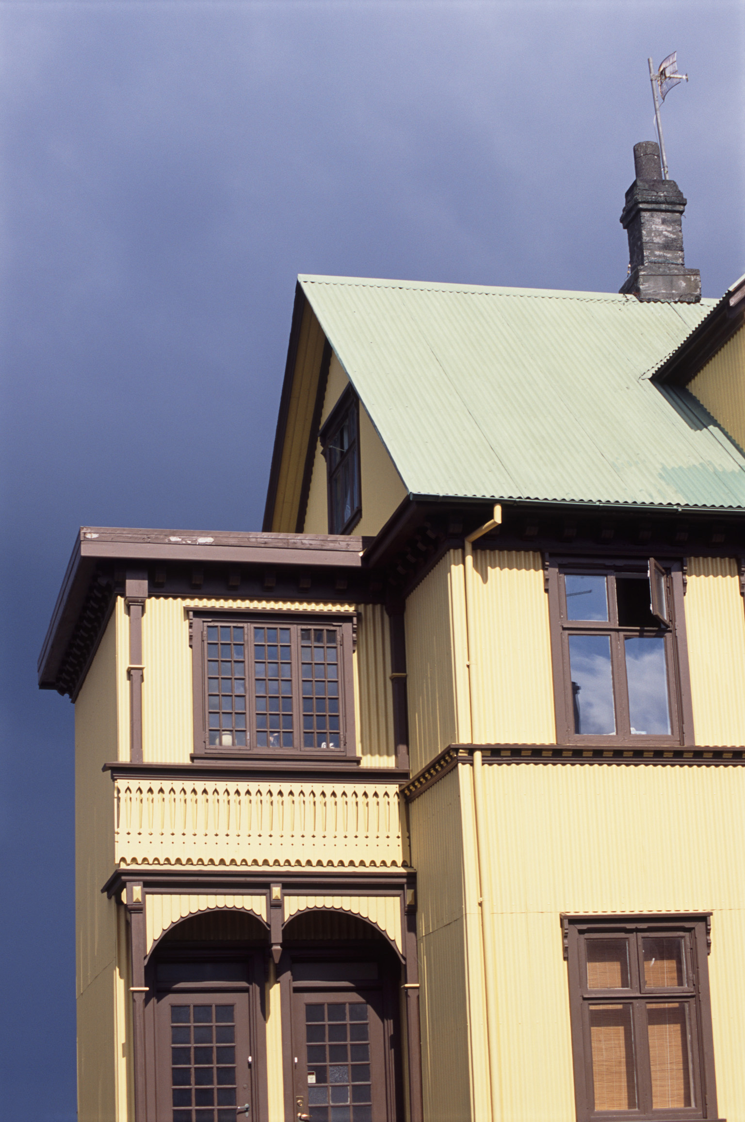 an image of Exterior view of the typical architectural style of a Reykjavik house, Iceland against a blue sky