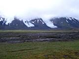 Ice flows or glaciers on a volcanic mountain peak shrouded in mist and cloud in Iceland