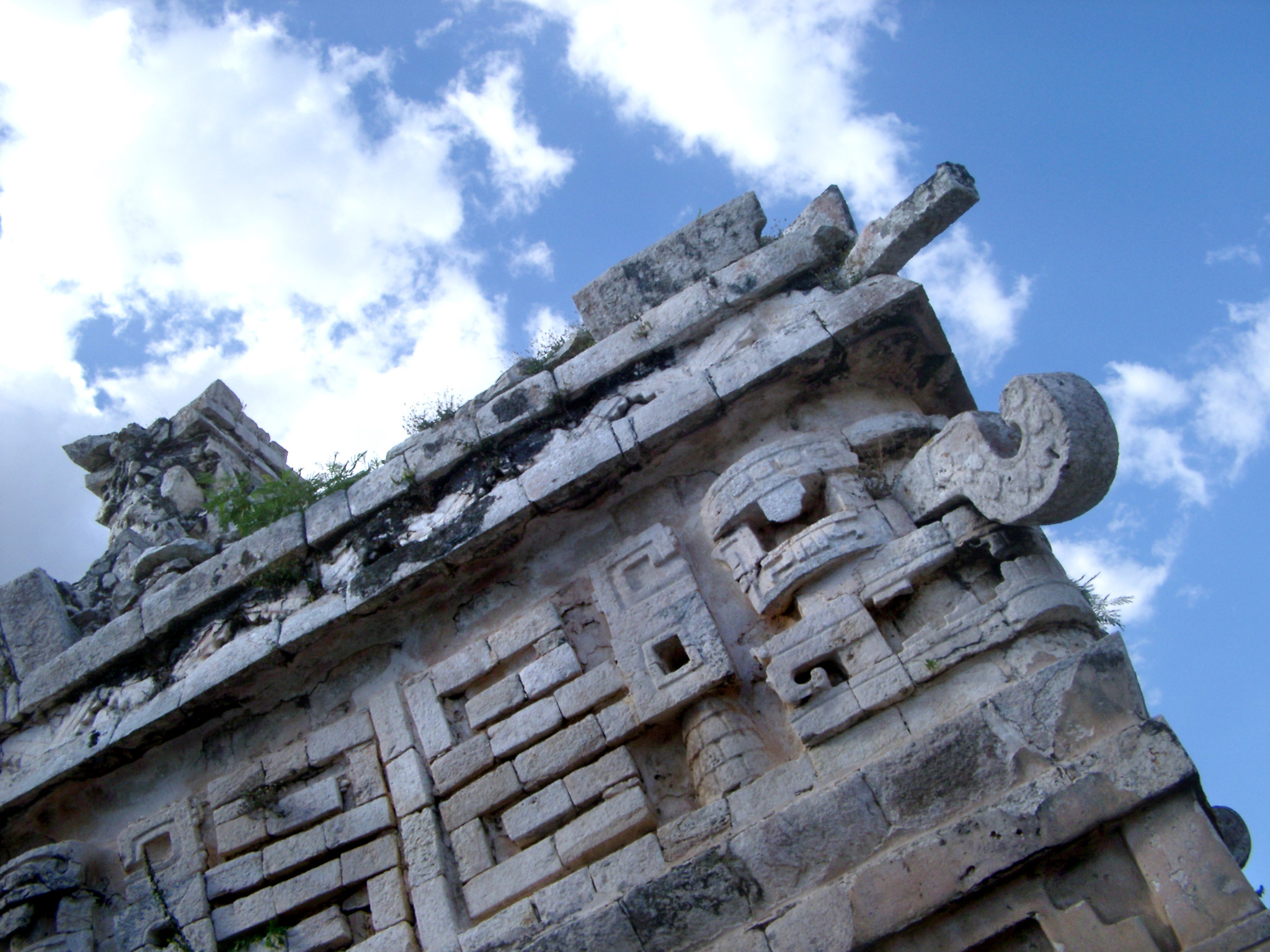 an image of Looking Up of Carvings at Chichen Itza Mayan Ruins Against Blue Sky, Yucatan, Mexico
