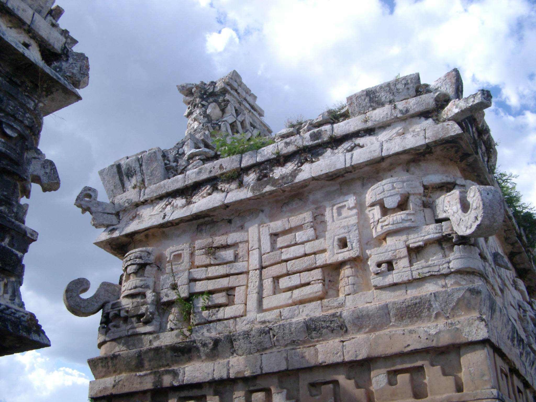 an image of Ornate stone carvings with tribal patterns and hooked corner stones at Chitzen Itza Mayan ruins, an important archaeological site in the Yucatan Peninsula, Mexico