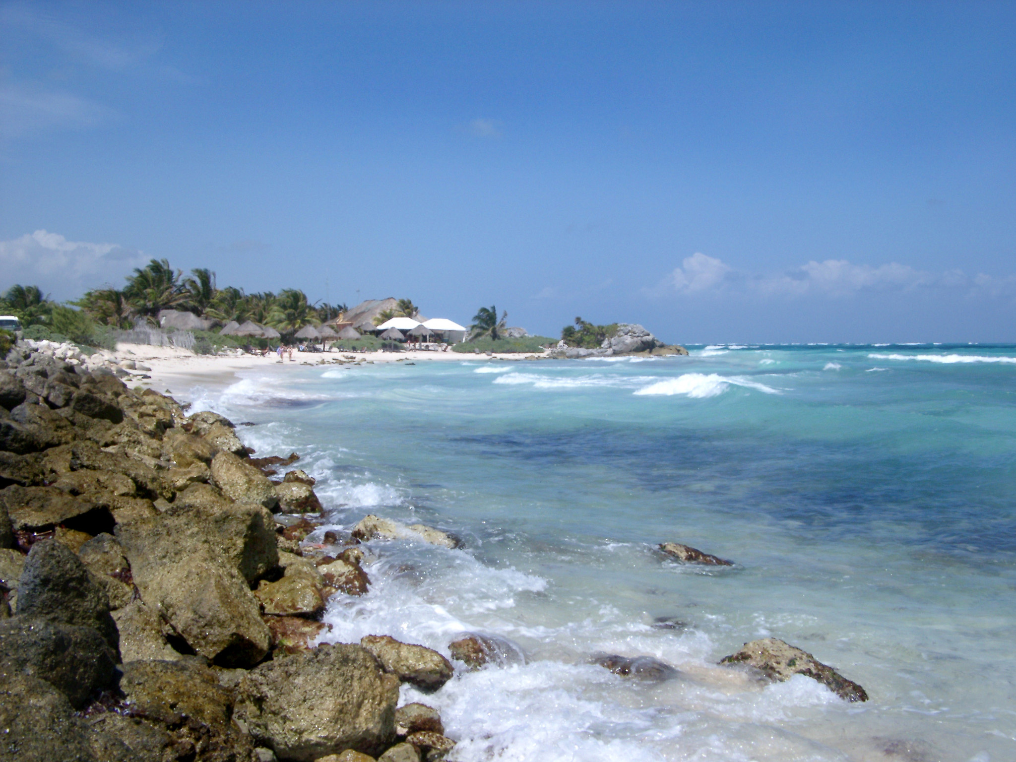 an image of Big Rocks at Seashore at a Beautiful Mexican Beach. Captured in Extensive View. Isolated on Light Blue Sky Background.