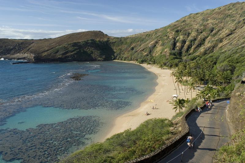 Scenic view of the golden sand of Hanuma Bay Beach, Ohau, Hawaii, a favorite spot for snorkeling and water sport