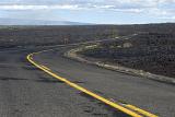 Road winding through a lava field in the Hawaiian Volcanoes National Park, Hawaii, USA