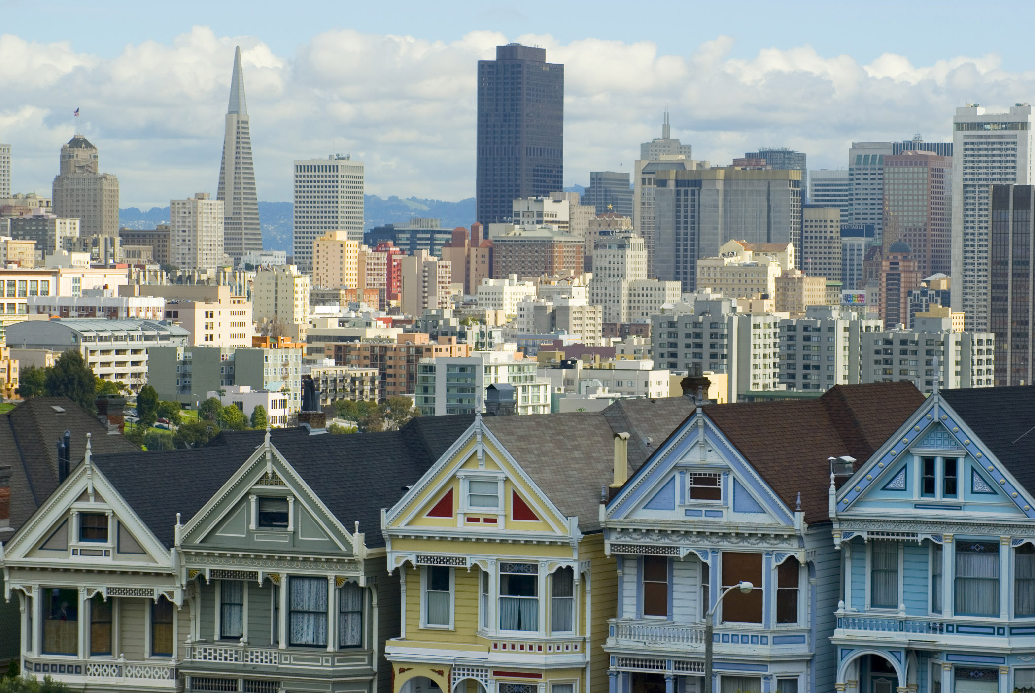 an image of Attractive Architectural Building Structures at Alamo Square San Francisco with Lighter Blue and White Sky Background.