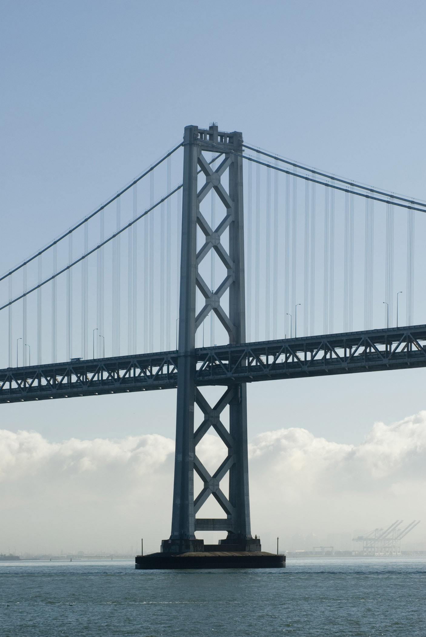 an image of View across the water of one of the support towers of San Francisco Bay bridge a landmark steel suspension bridge in San Francisco, California