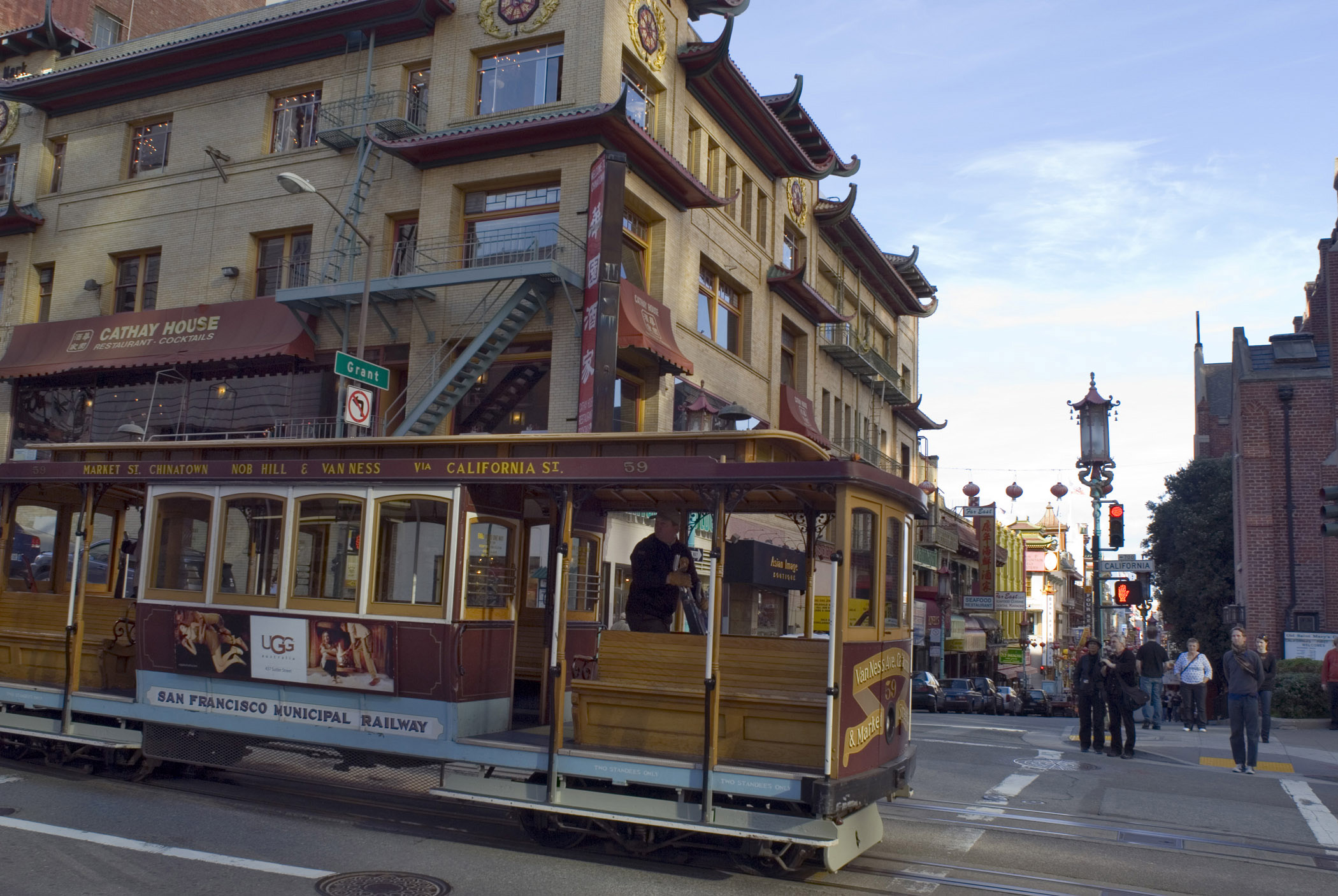 an image of Vintage Vehicle Passing on Street of Chinatown in San Francisco. Isolated on Old Buildings. Captured in the day Time.