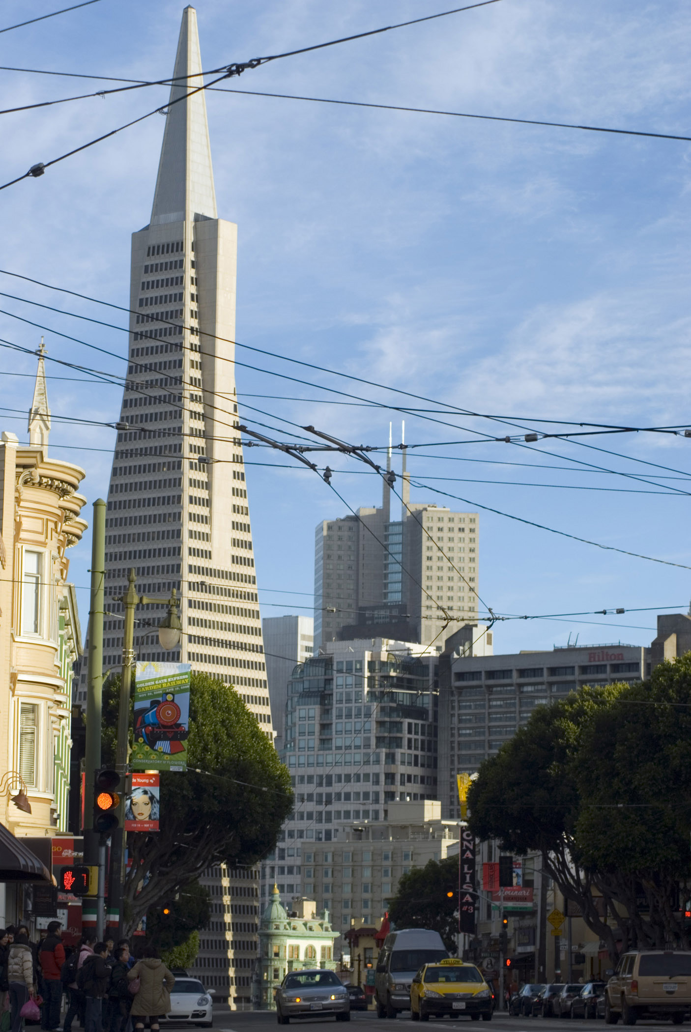 an image of Transamerica Pyramid and Other Architectural City Buildings at Columbus Avenue San Francisco on Light Blue Sky Background.
