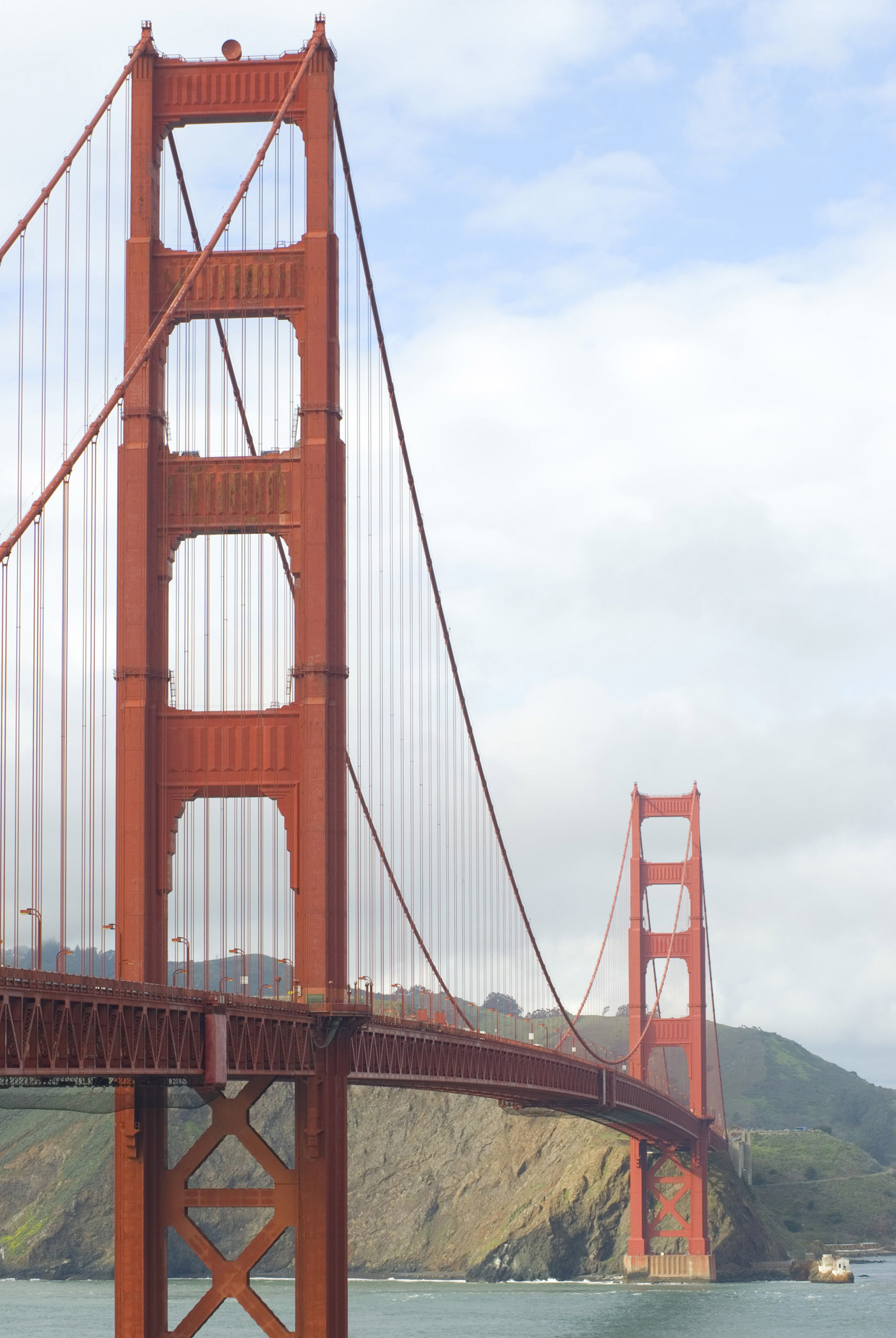 an image of View along the length of the Golden Gate Bridge in San Francisco showing the suspension cables and red paintwork of the steel