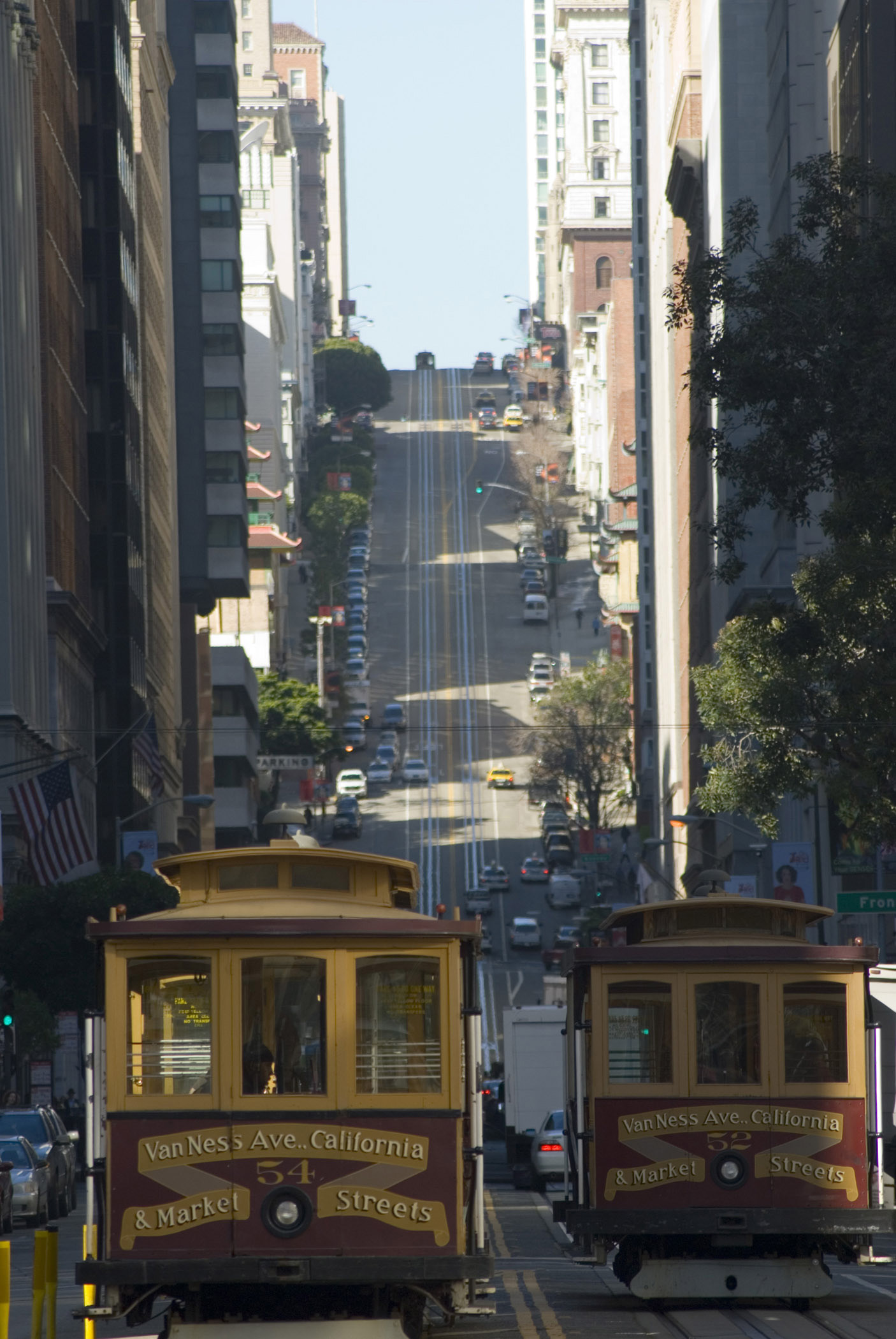 an image of Trams passing each other on a steep urban street in Nob Hill,an affluent neighbourhood of San Francisco, California, USA