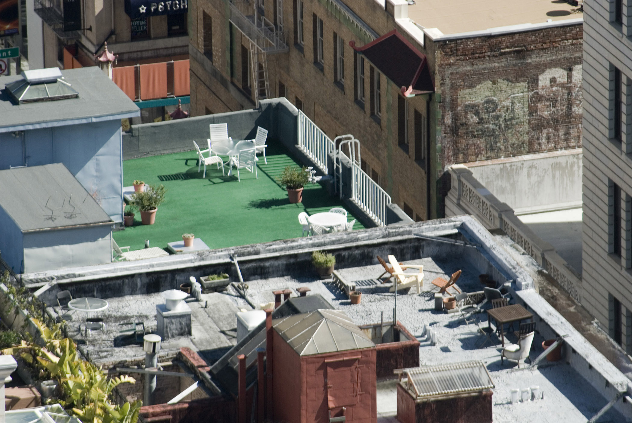 an image of View looking down on San Francisco rooftops with recreational areas and sun loungers for enjoying the summer sunshine